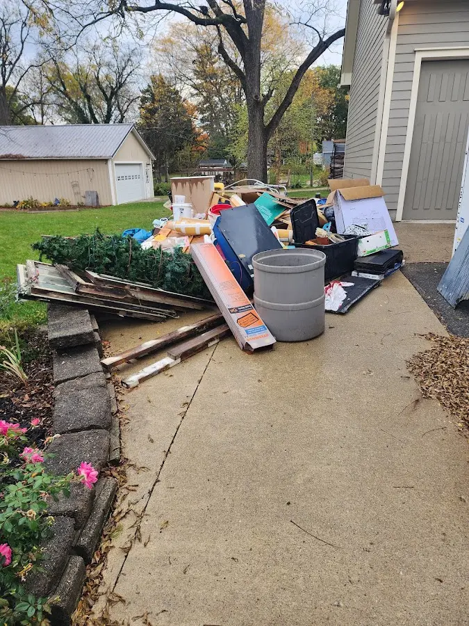 Dumpster being loaded with debris for Commercial Dumpster Rental in Lewisburg